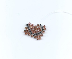 See? I weave some seed beads into a letter --- it's all handwork!